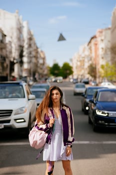 Young beautiful woman on the background of cars photo