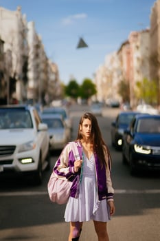 Young beautiful woman on the background of cars photo
