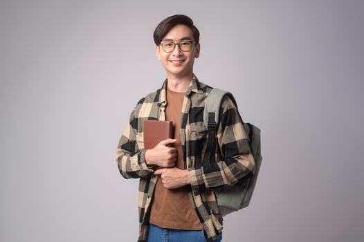 Portrait of an Asian university student over white background studio, education concept. photo