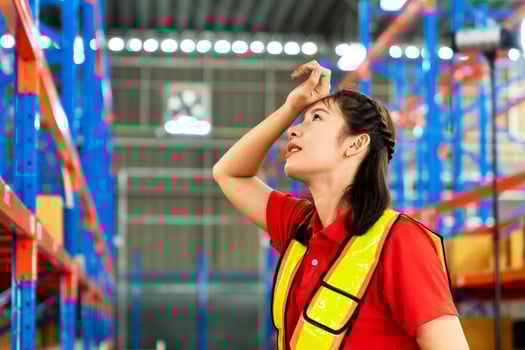 The female engineer was tired from work, was wiping her hands, wiping sweat on her face and standing at the forklift in a factory in Industrial Engineering worker concept photo