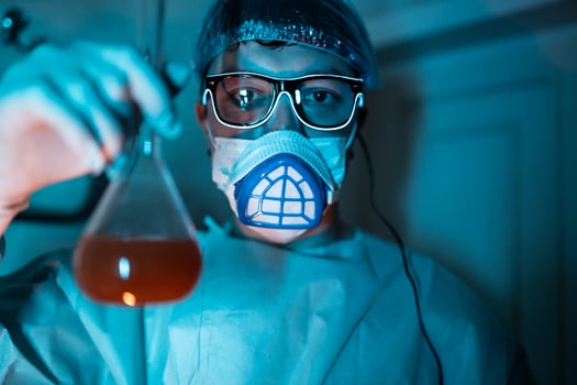 Young male researcher carrying out scientific experiment. photo