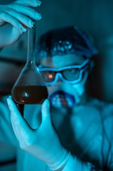 Young male researcher carrying out scientific experiment. photo
