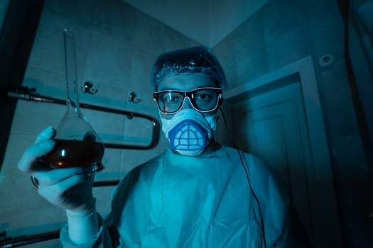 Young male researcher carrying out scientific experiment. photo