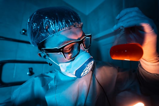 Young male researcher carrying out scientific experiment. photo