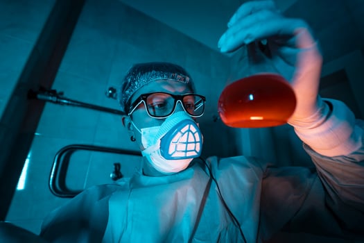 Young male researcher carrying out scientific experiment. photo
