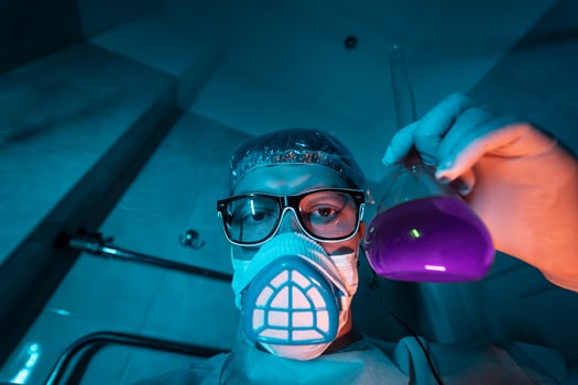Young male researcher carrying out scientific experiment. photo