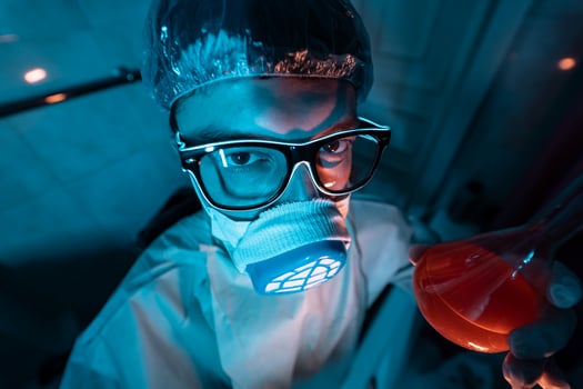 Young male researcher carrying out scientific experiment. photo