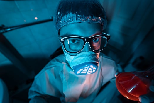 Young male researcher carrying out scientific experiment. photo