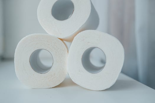 Toilet paper shortage concept with stacked rolls. photo