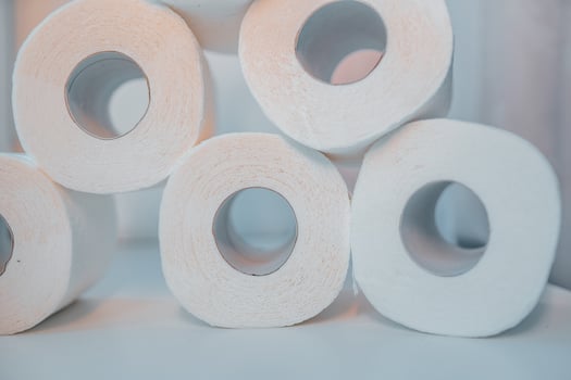 Toilet paper shortage concept with stacked rolls. photo