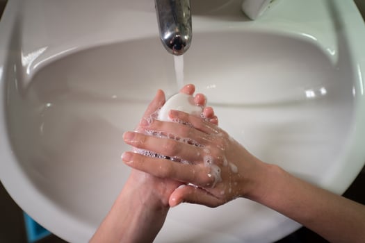 Man washing hands to protect against the coronavirus photo