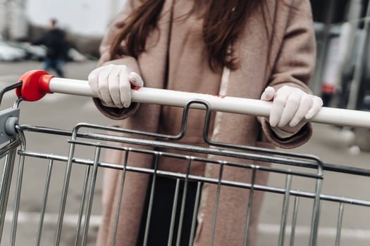 Young woman wearing protection face mask against coronavirus 2019-nCoV pushing a shopping cart. photo