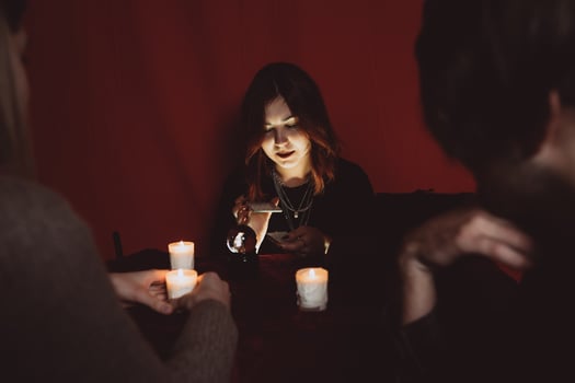 Group of people and woman fortune teller with crystal ball photo