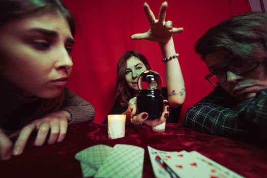 Group of people and woman fortune teller with crystal ball photo