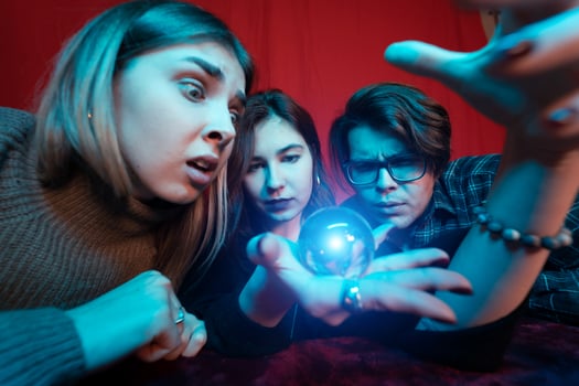 Group of people and woman fortune teller with crystal ball photo