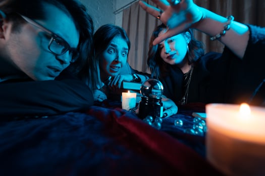 Group of people and woman fortune teller with crystal ball photo
