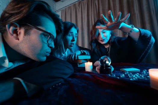 Group of people and woman fortune teller with crystal ball photo