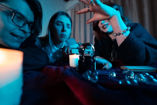 Group of people and woman fortune teller with crystal ball photo