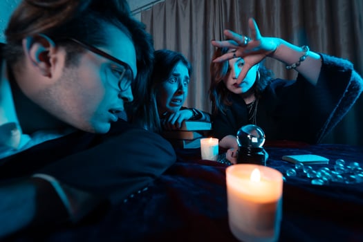 Group of people and woman fortune teller with crystal ball photo