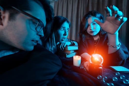 Group of people and woman fortune teller with crystal ball photo