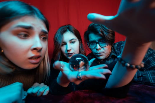 Group of people and woman fortune teller with crystal ball photo