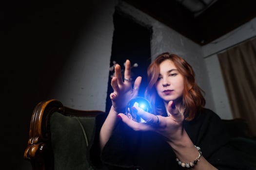 Woman in black suit holding crystal ball photo