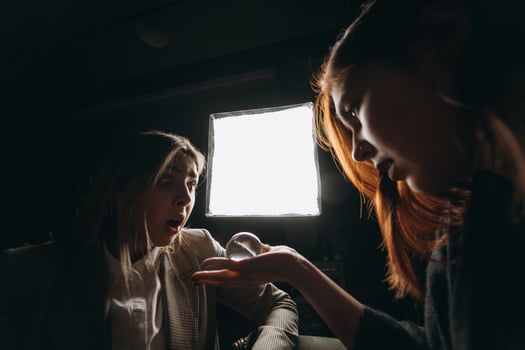 Woman and woman fortune teller with crystal ball photo