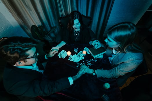 People hold hands of night at table with candles photo