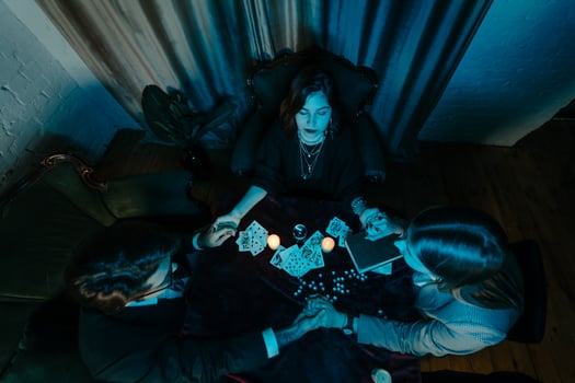 People hold hands of night at table with candles photo
