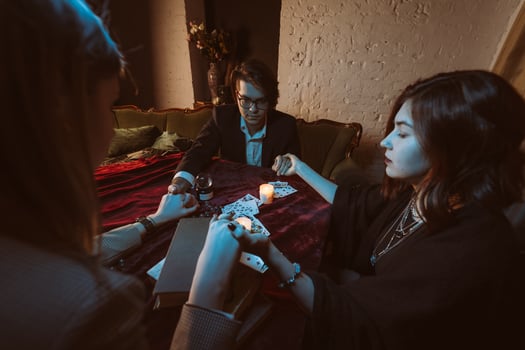 People hold hands of night at table with candles photo