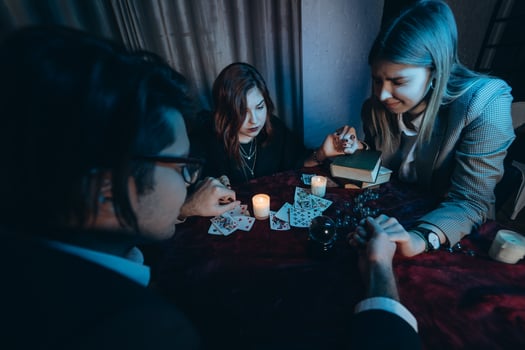 People hold hands of night at table with candles photo