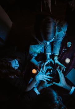 Group of people and woman fortune teller with crystal ball photo