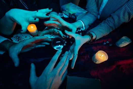 Group of people and woman fortune teller with crystal ball photo