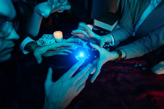Group of people and woman fortune teller with crystal ball photo