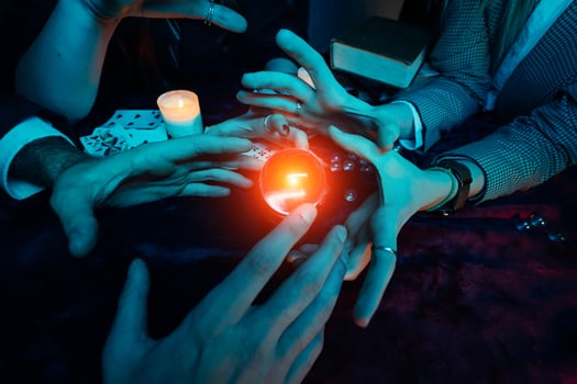 Group of people and woman fortune teller with crystal ball photo
