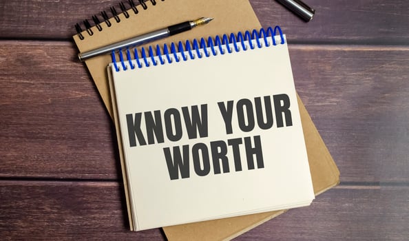 Know Your Worth words on notepad and wooden background photo
