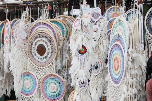 Various handcrafted white multi-colored dreamcatchers are sell in the market. photo