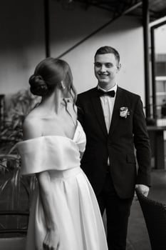 young couple bride and groom in a white short dress photo
