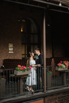 young couple bride and groom in a white short dress photo