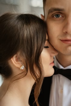young couple bride and groom in a white short dress photo