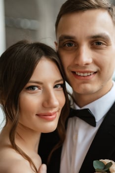 young couple bride and groom in a white short dress photo