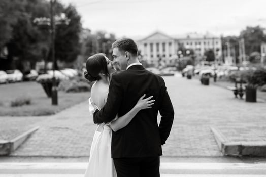 young couple bride and groom in a white short dress photo
