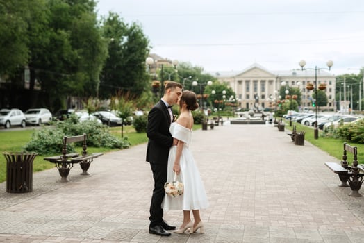 young couple bride and groom in a white short dress photo