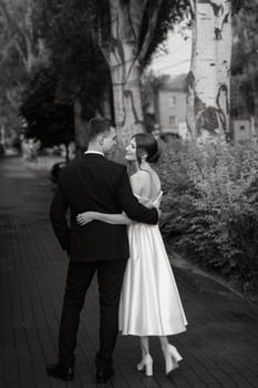 young couple bride and groom in a white short dress photo