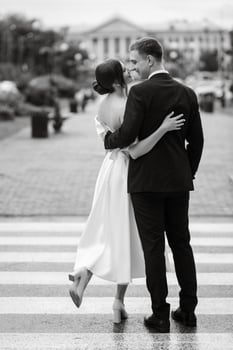 young couple bride and groom in a white short dress photo