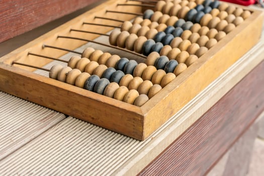 Old wooden abacus on wooden background. Close-up. photo