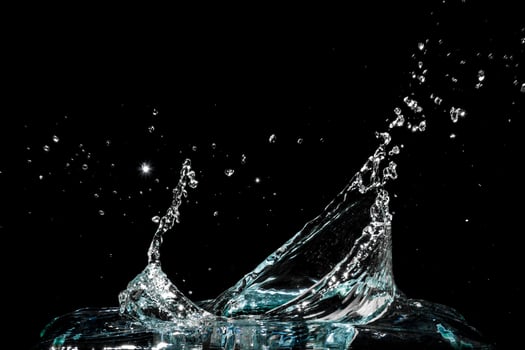 Water splash isolated on black background photo
