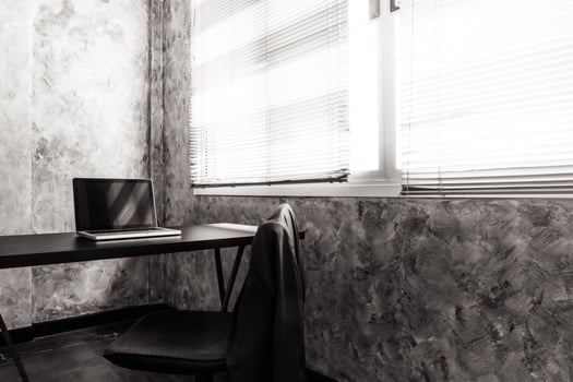 Laptop on the desk in the office room. Vintage tone photo