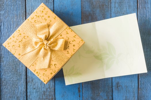 Top view of Gift boxes with card on wooden table background. photo
