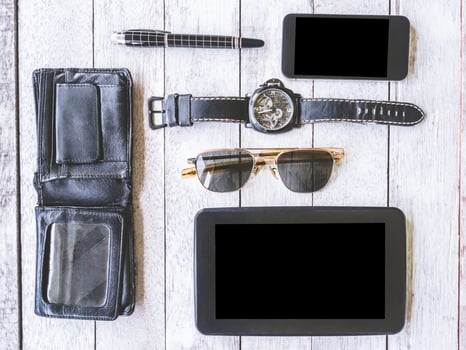 Top view of male accessories and gadgets on the wooden table. photo